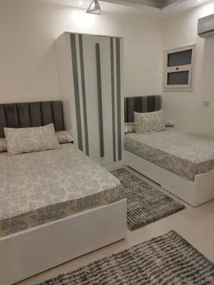 a bedroom with two beds and two rugs at Seaview Classy 2Bedroom Suite with beach access in Hurghada