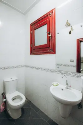 a bathroom with a toilet and a sink and a mirror at The Golden House on the Avenue of Sphinxes in Luxor