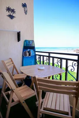 a table and two chairs on a balcony with the beach at 4,5 Zimmer Kiteapartment Selena Bay in Hurghada
