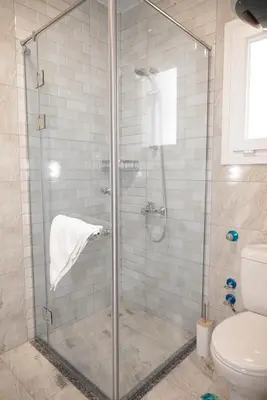 a bathroom with a glass shower with a toilet at 4,5 Zimmer Kiteapartment Selena Bay in Hurghada