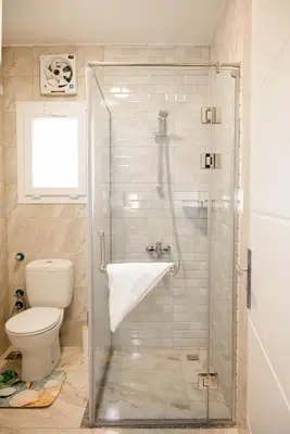 a bathroom with a glass shower with a toilet at 4,5 Zimmer Kiteapartment Selena Bay in Hurghada