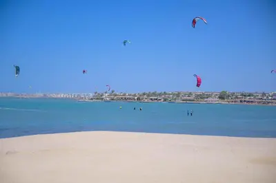 a group of people flying kites over the ocean at 4,5 Zimmer Kiteapartment Selena Bay in Hurghada