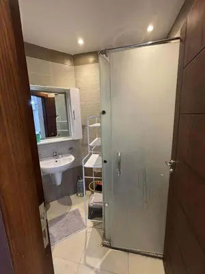 a bathroom with a shower and a sink at Sunrise Luxury Apartment in Hurghada