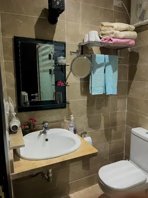 a bathroom with a sink and a toilet and a mirror at Studio Mirage Bay in Hurghada