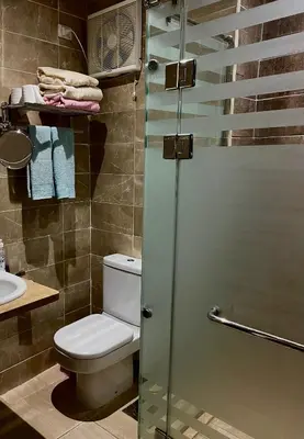 a bathroom with a toilet and a shower at Studio Mirage Bay in Hurghada