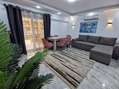 a living room with a couch and a table at Selena Bay Resort - VIP apartment with Private Beach Area in Hurghada