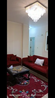 a living room with a red couch and a coffee table at Fayrouz Compound in Hurghada
