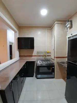 a large kitchen with a stove and a sink at Fayrouz Compound in Hurghada