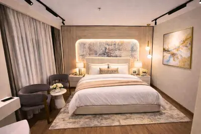 a bedroom with a large bed and a table and chairs at Dahabiya Hathor Nile Cruise - Saturday from Luxor 4 Nights , Wednesday from Aswan 3 Nights & Available for Charter in Luxor