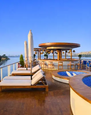 a deck on a cruise ship with chairs and tables at Dahabiya Hathor Nile Cruise - Saturday from Luxor 4 Nights , Wednesday from Aswan 3 Nights & Available for Charter in Luxor