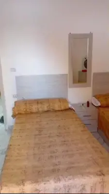 a room with a bed and a mirror in it at La bella resort touristic walkway hurghada in Hurghada