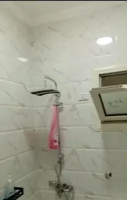 a bathroom with a shower with a pink towel at La bella resort touristic walkway hurghada in Hurghada