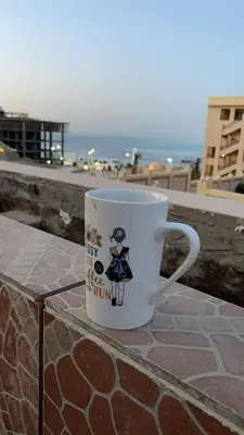 a coffee cup sitting on top of a ledge at Sea View luxury chalet in Hurghada