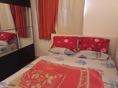 a small bedroom with a bed with red pillows at Sea View luxury chalet in Hurghada