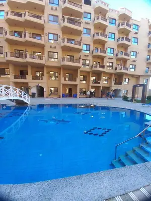 a large swimming pool in front of a building at Tartils Beach Resort Al-Ahyaa in Hurghada