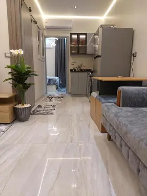 a living room with a couch and a kitchen at Solitaire in Hurghada