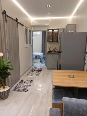 a room with a kitchen and a living room at Solitaire in Hurghada