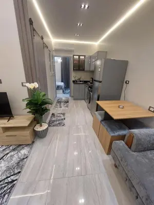 a living room with a table and a kitchen at Solitaire in Hurghada