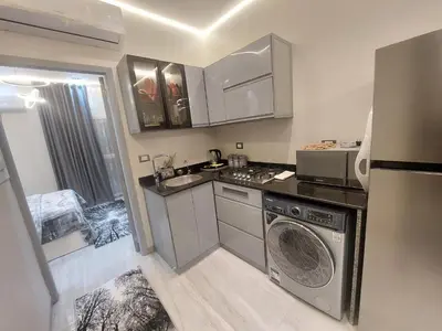 a kitchen with a washing machine and a sink at Solitaire in Hurghada