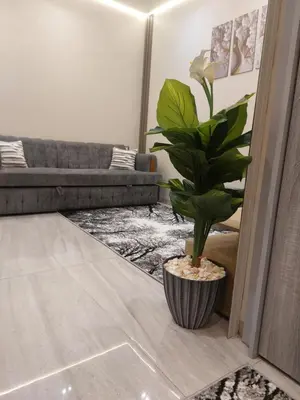 a living room with a couch and a plant at Solitaire in Hurghada