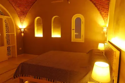 a bedroom with a bed with two lights on it at Mountian View Domes in Al Aqālitah