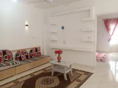 a living room with two couches and a table at Bait el gabal in Al Aqālitah