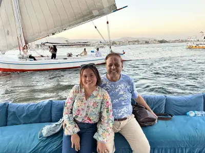 a man and a woman sitting on a boat at The authentic Egyptian house in ‘Ezbet Abu Ḥabashi