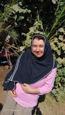 a woman wearing a black scarf around her head at The authentic Egyptian house in ‘Ezbet Abu Ḥabashi