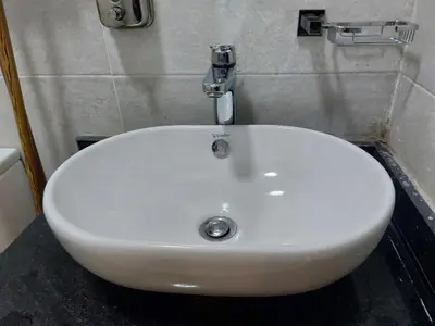 a white sink with a faucet in a bathroom at solitaire in Hurghada