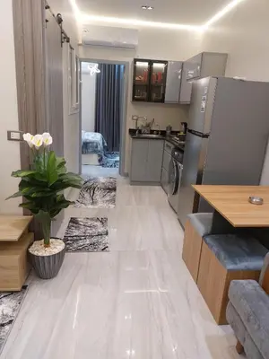a kitchen and living room with a refrigerator and a table at solitaire in Hurghada