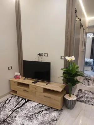 a television on a wooden entertainment center in a living room at solitaire in Hurghada