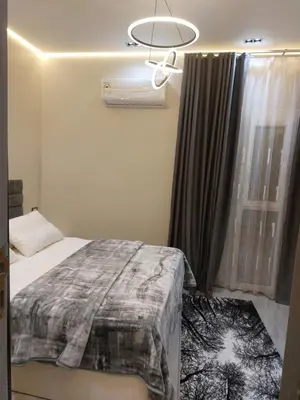 a bedroom with a bed and a window with a fan at solitaire in Hurghada