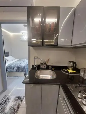 a kitchen with a sink and a room with a bed at solitaire in Hurghada