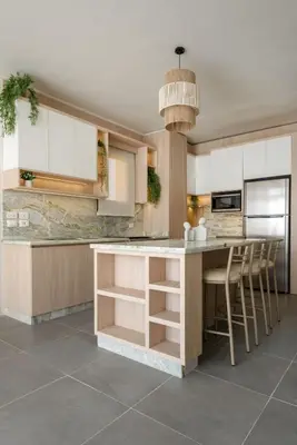 a kitchen with white cabinets and a island with bar stools at The Best House in Makadi in Hurghada