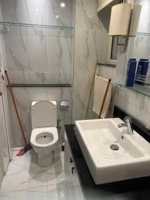 a bathroom with a white toilet and a sink at Veranda resort in Hurghada