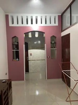 a room with a purple wall and a door at Durrat al-Nahr in Luxor