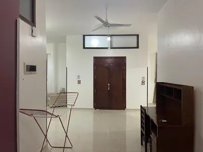 a living room with a ceiling fan and a door at Durrat al-Nahr in Luxor