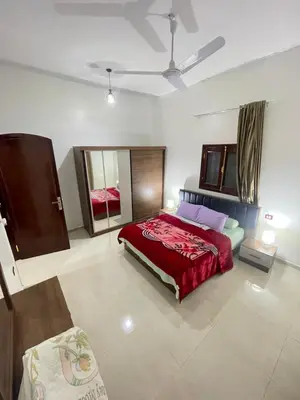 a bedroom with a large red bed in a room at Durrat al-Nahr in Luxor