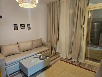 a living room with a couch and a coffee table at Modern apartment with pool view in Port Ghalib in Port Ghalib