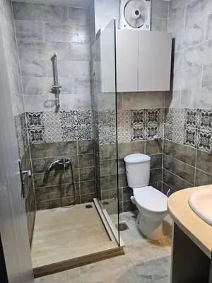 a bathroom with a shower with a toilet and a sink at Modern apartment with pool view in Port Ghalib in Port Ghalib