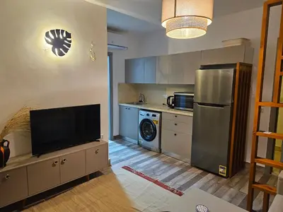 a kitchen with a stainless steel refrigerator and a dishwasher at Modern apartment with pool view in Port Ghalib in Port Ghalib