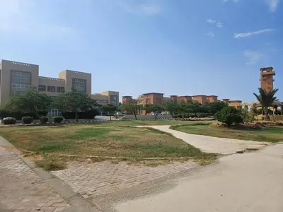 a park in front of a city with tall buildings at Modern apartment with pool view in Port Ghalib in Port Ghalib