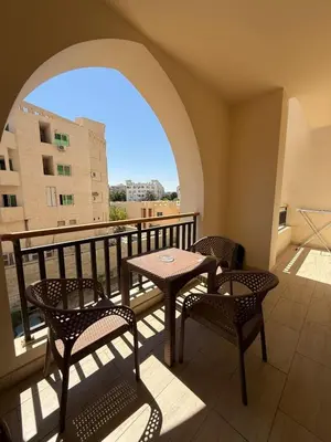 a balcony with a table and chairs and a window at Casa Bonita 2307 in Hurghada