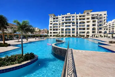 a swimming pool in front of a large building at Casa Bonita 2307 in Hurghada