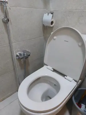 a white toilet in a bathroom with a roll of toilet paper at سولتير in Hurghada