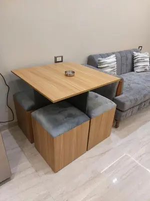 a living room with a wooden table and a couch at سولتير in Hurghada