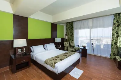 a hotel room with a bed and a large window at Contenintal Rosa Boho Aquapark Hotel 3 Stars in Hurghada