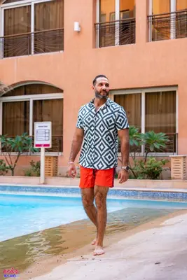 a man standing in the water near a swimming pool at Contenintal Rosa Boho Aquapark Hotel 3 Stars in Hurghada