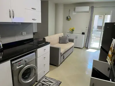 a kitchen and living room with a washing machine at rezort Al Hambra, rezort Princess in Hurghada