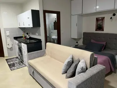 a living room with a couch and a bed at rezort Al Hambra, rezort Princess in Hurghada